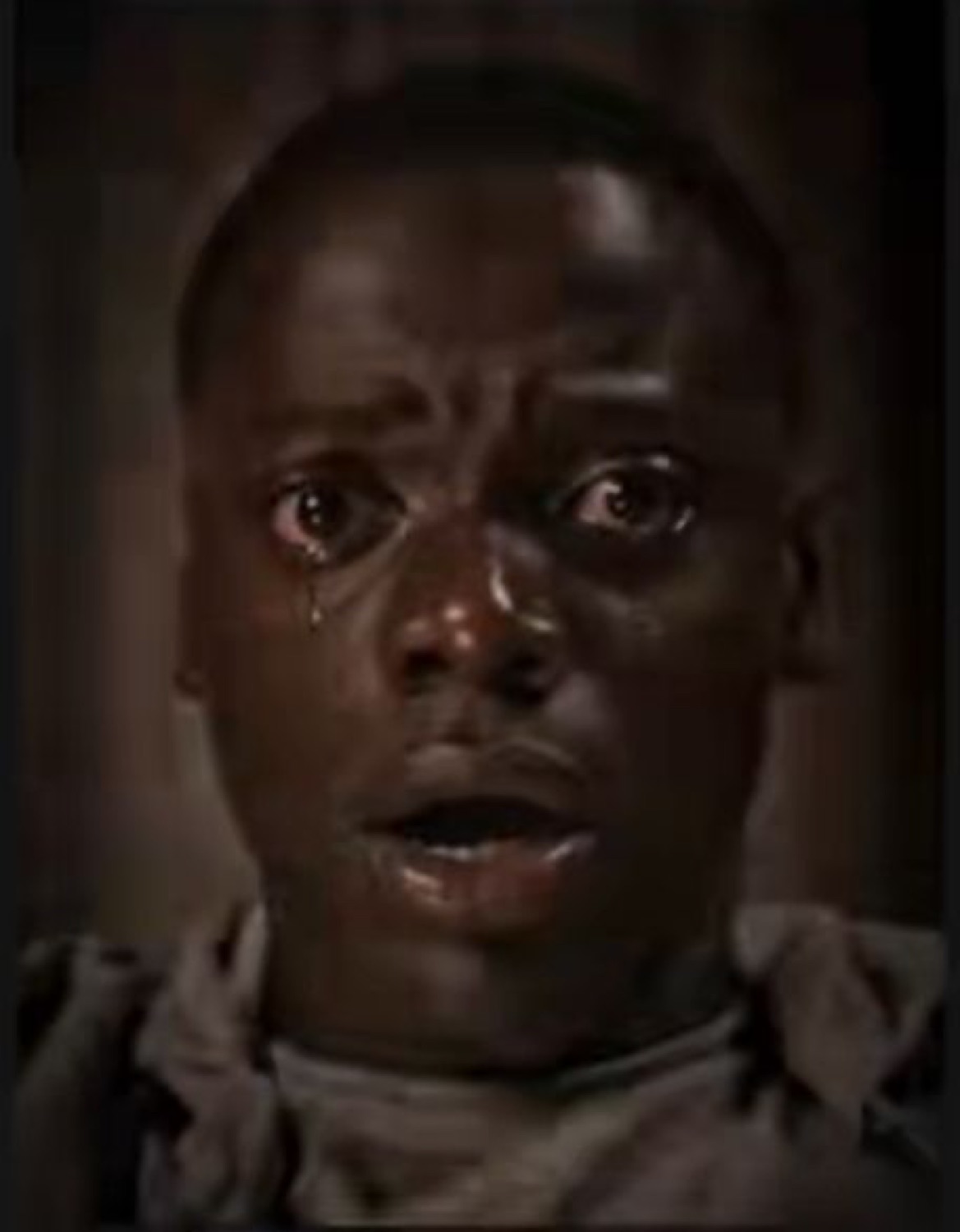 Man frozen with tears streaming down his face and a terrified open mouth
