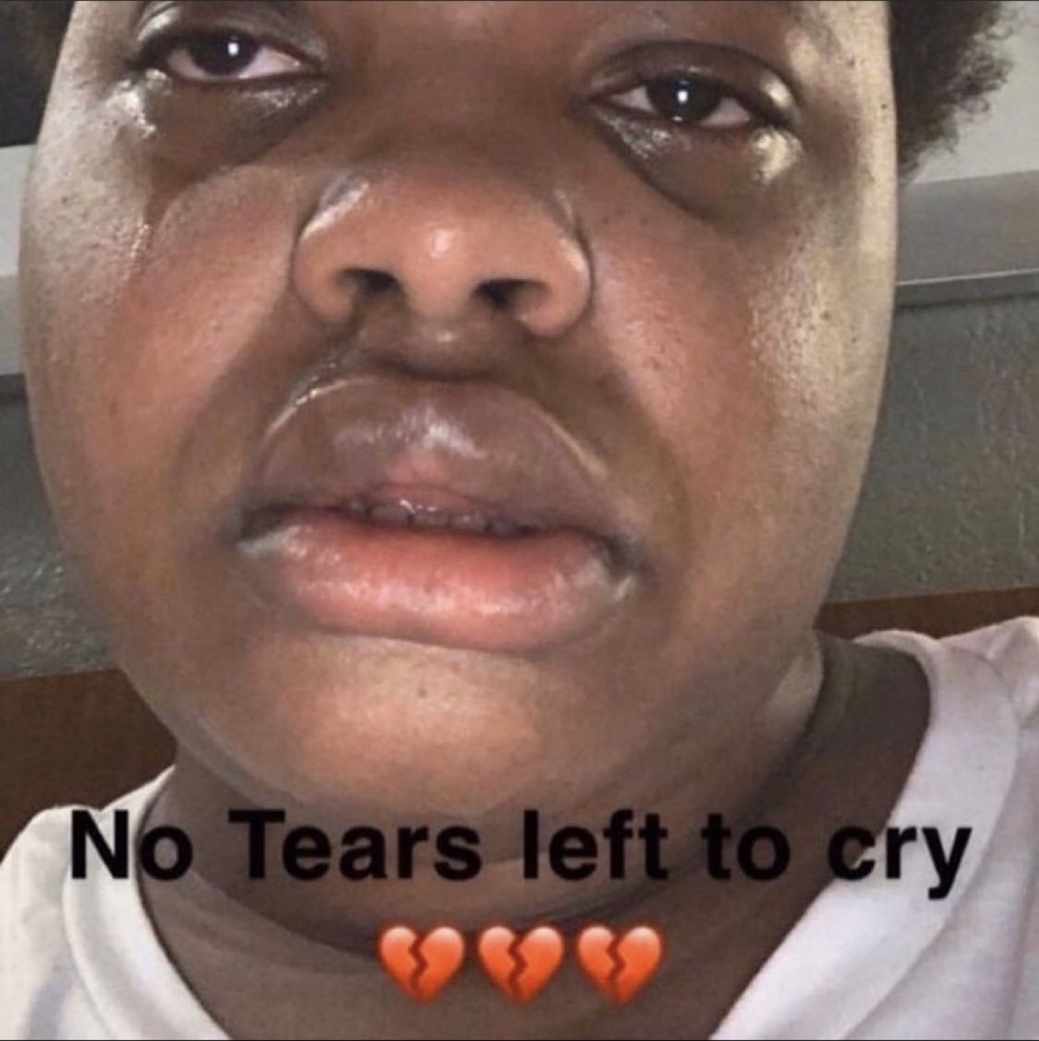 Teary-eyed close-up captioned 'No Tears left to cry' with three broken-heart emojis