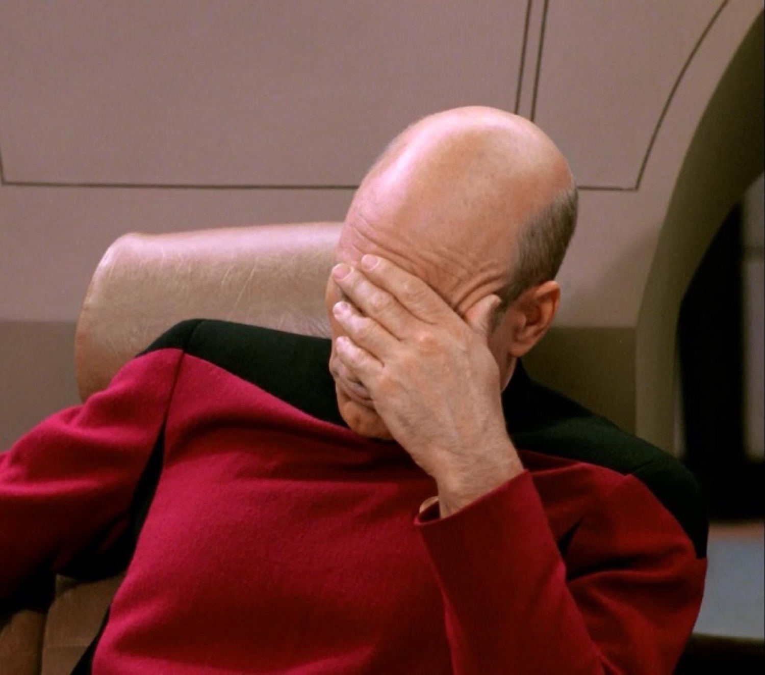 Captain Picard slumped in his chair doing a full facepalm