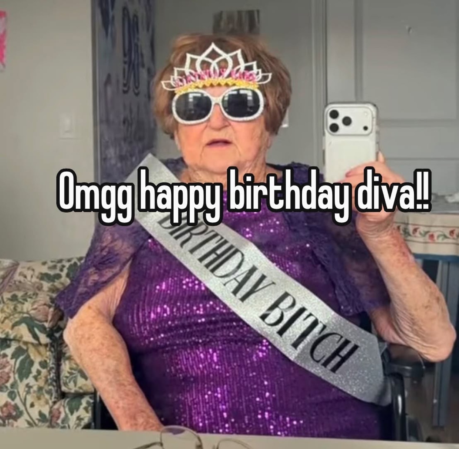 Older woman in a tiara, sunglasses and birthday sash taking a mirror selfie: 'Omgg happy birthday diva!!'
