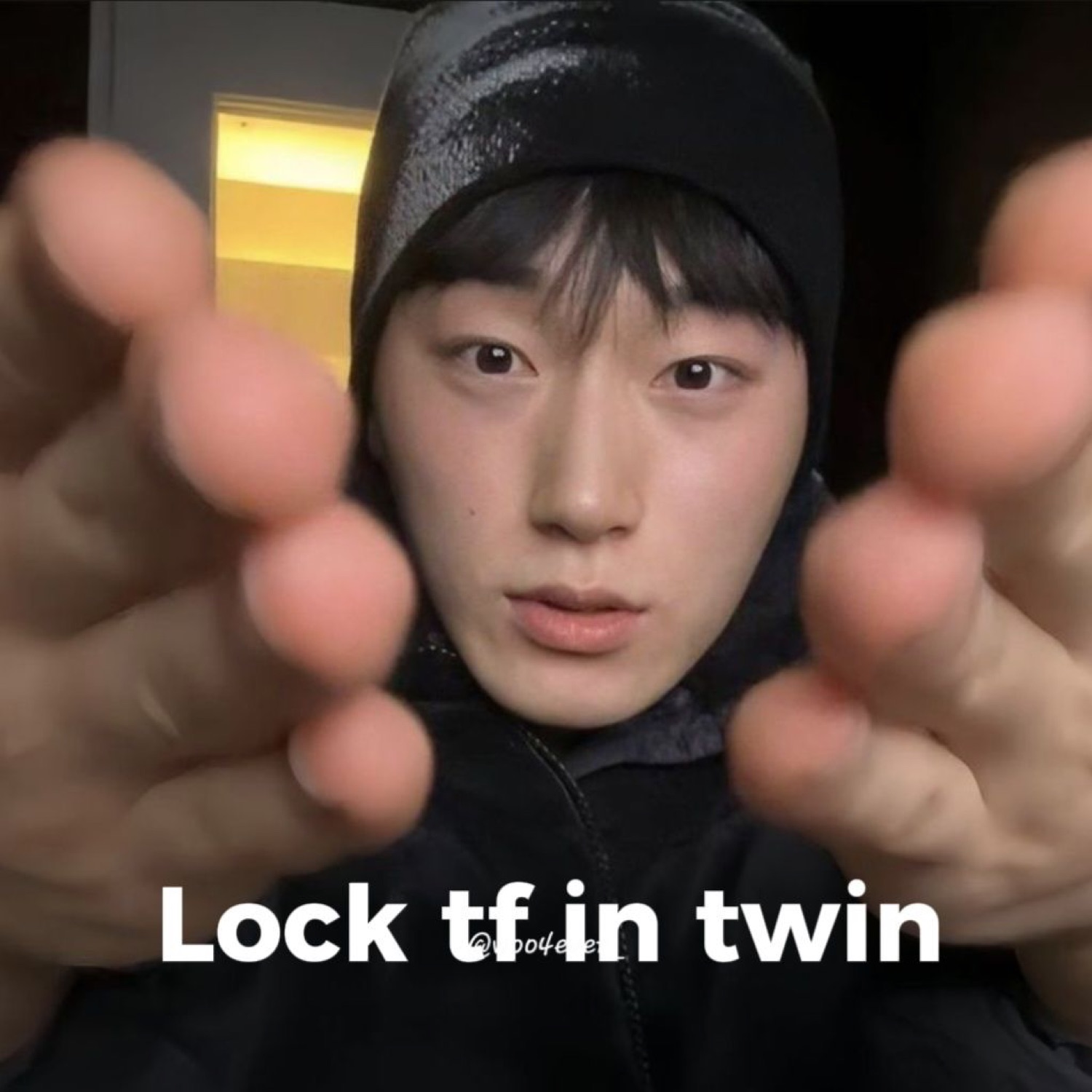 Guy in a black beanie reaching both hands at the camera, captioned 'Lock tf in twin'