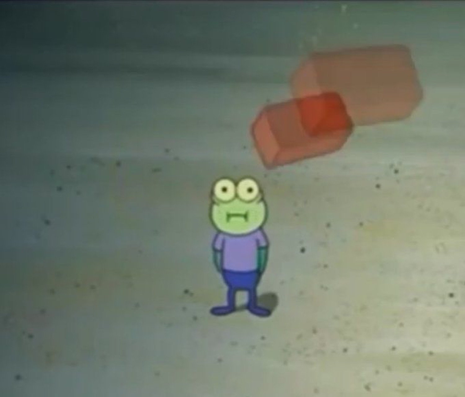 Little green cartoon fish standing alone in a wasteland with a blank stare
