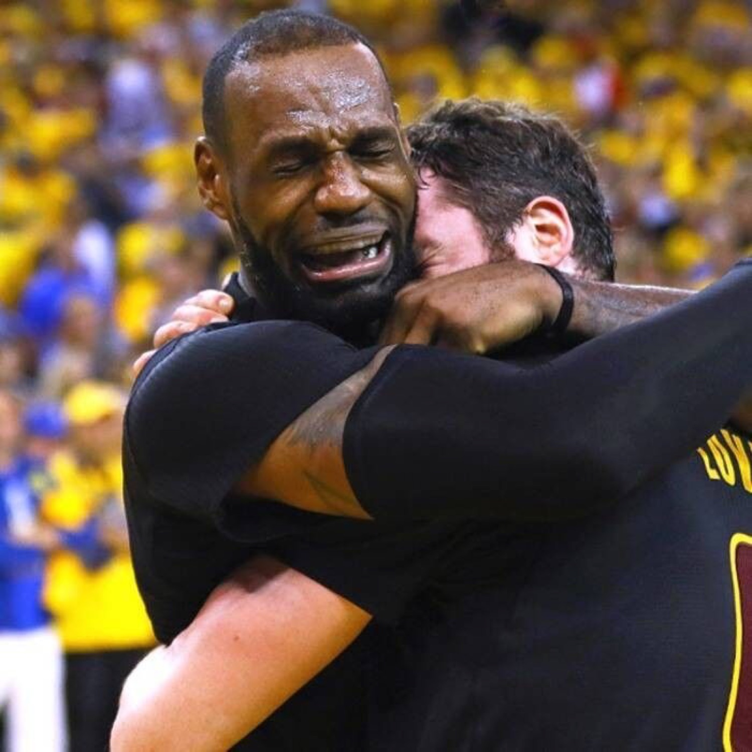 LeBron James sobbing while hugging a teammate after a win