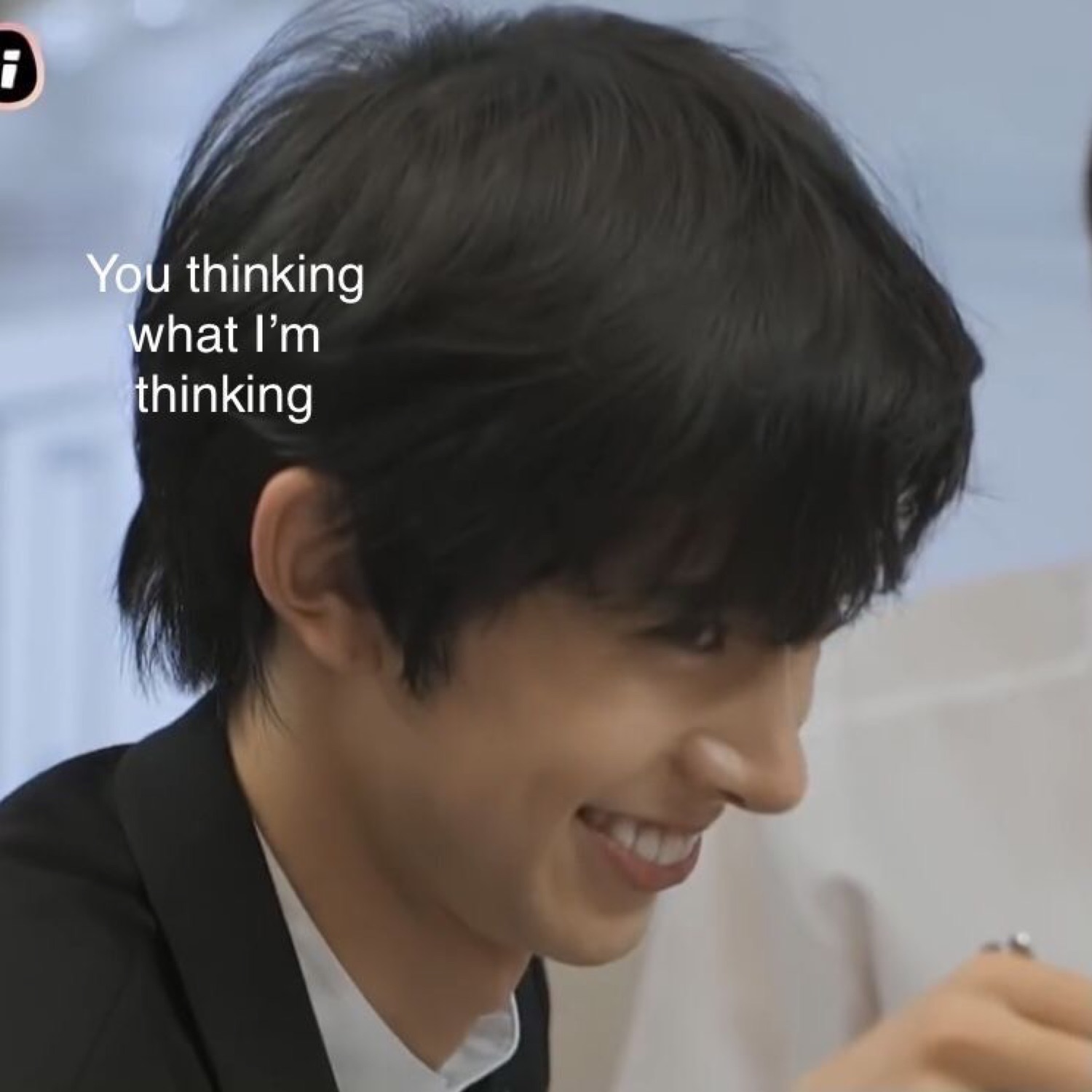 Young man in a suit smiling knowingly, captioned 'You thinking what I'm thinking'