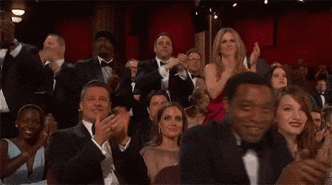Celebrity audience at an awards show giving a standing ovation