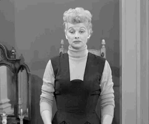 Lucille Ball shrugging in black and white