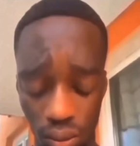 Man with his eyes closed and head lowered looking utterly defeated