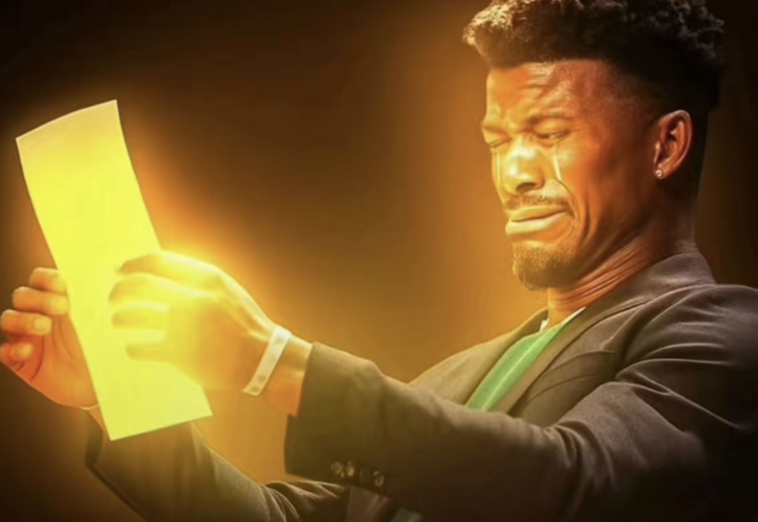 Jimmy Butler tearfully reading a glowing piece of paper