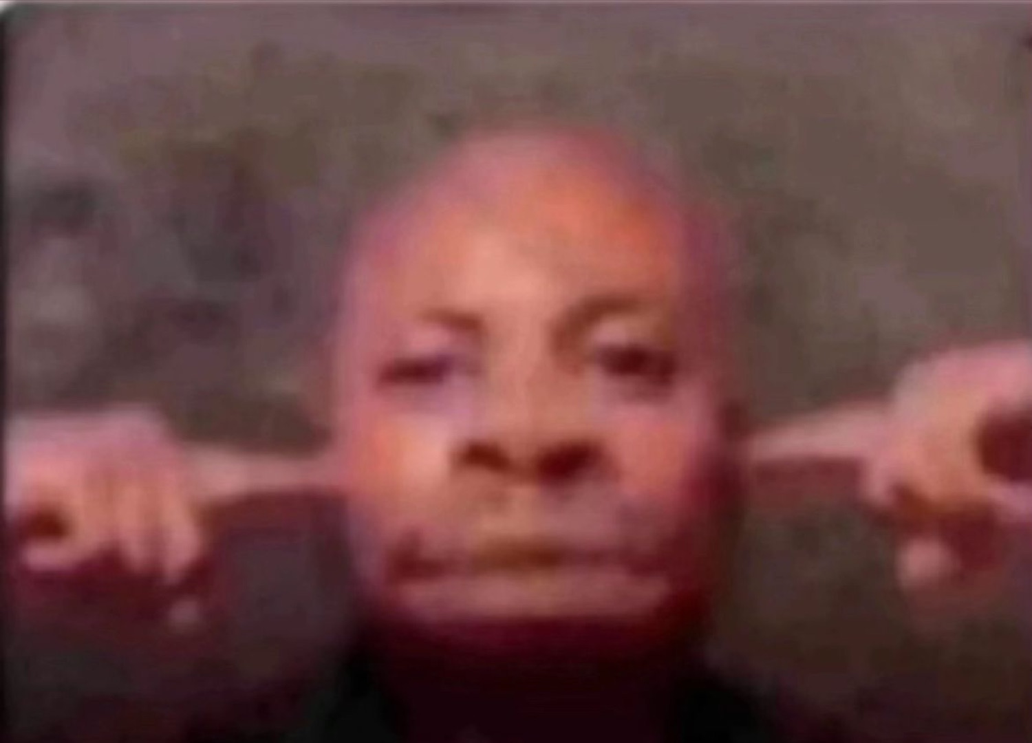 Grainy face pointing off to both sides with a flat, unamused expression