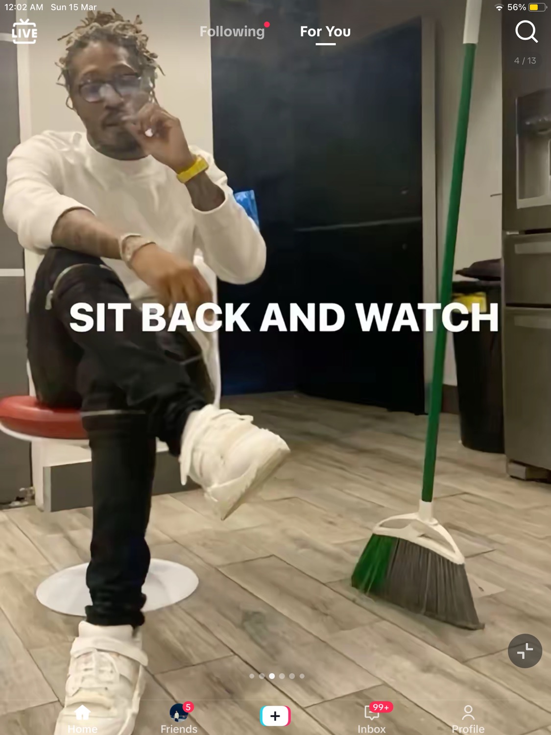 Future sitting on a stool with a broom on his foot under 'SIT BACK AND WATCH'