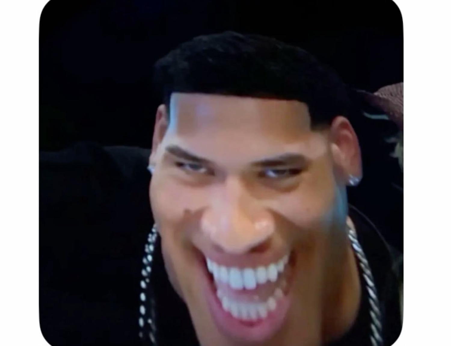 Love Island USA's Corbin with a stretched, distorted grin