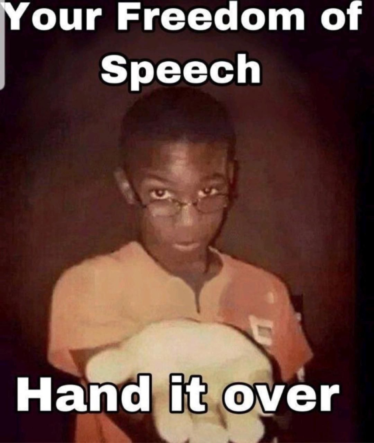 Dim photo of a boy holding out an open hand captioned 'Your Freedom of Speech / Hand it over'
