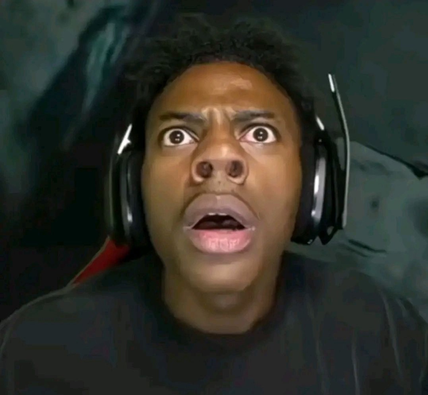 Streamer in headphones frozen mid-gasp with eyes wide and jaw dropped