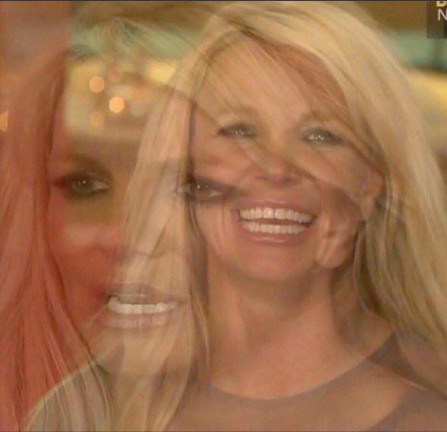 Double-exposed blur of a blonde woman laughing, ghosted over her own face