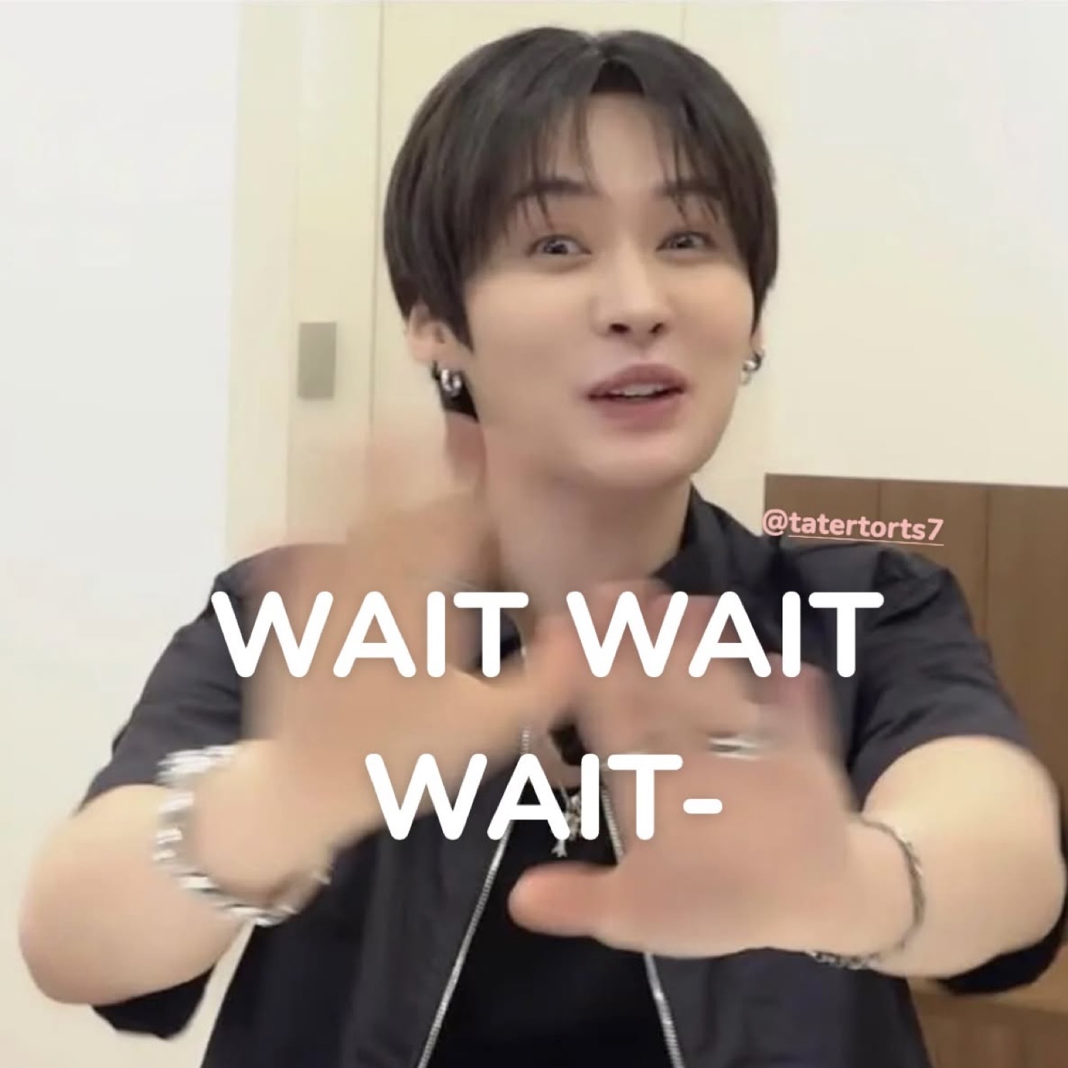 K-pop idol throwing his hands up captioned 'WAIT WAIT WAIT-'