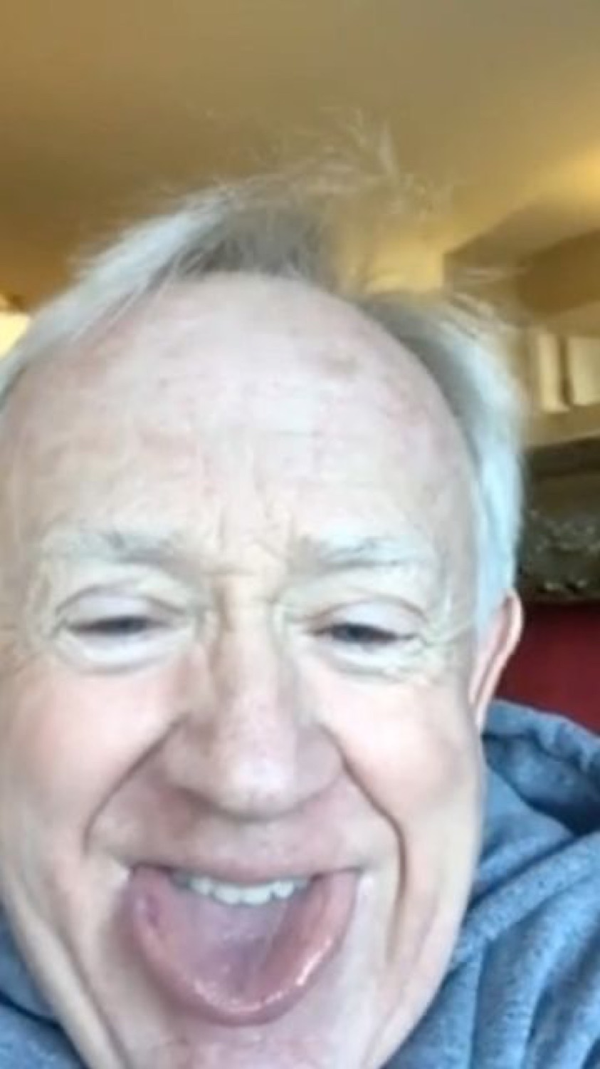 Older man sticking his tongue out and grinning straight at the camera