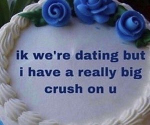 Blue-flower cake iced with 'ik we're dating but i have a really big crush on u'