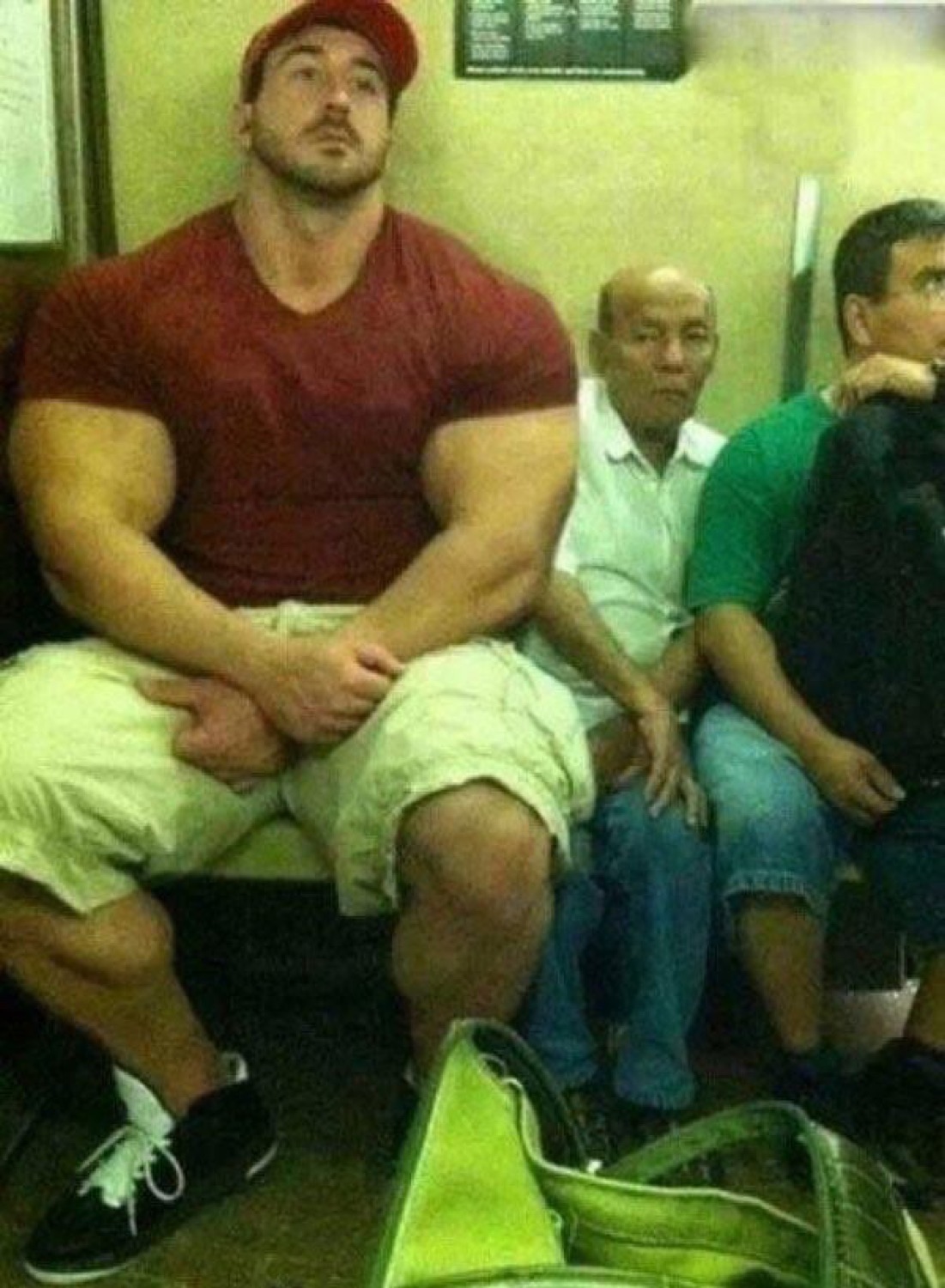 Massive bodybuilder squeezed onto a subway seat next to tiny old men