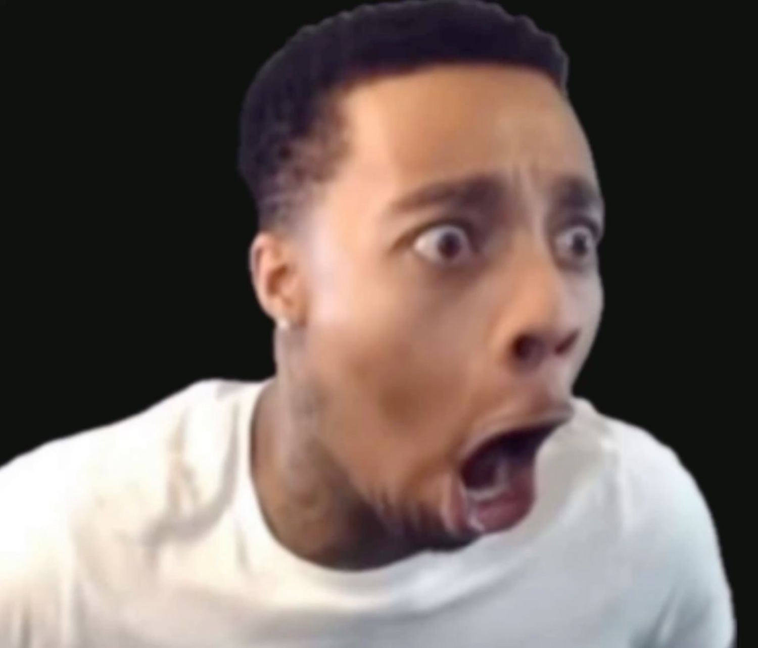 Man wide-eyed and mouth agape in absolute shock against a black background
