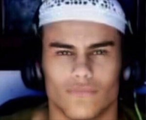 Guy in a white durag and headphones giving a flat, deadpan stare into the camera