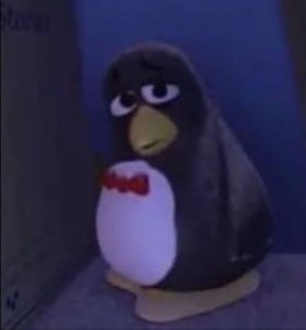 Little toy penguin with a bow tie and droopy, disappointed eyes