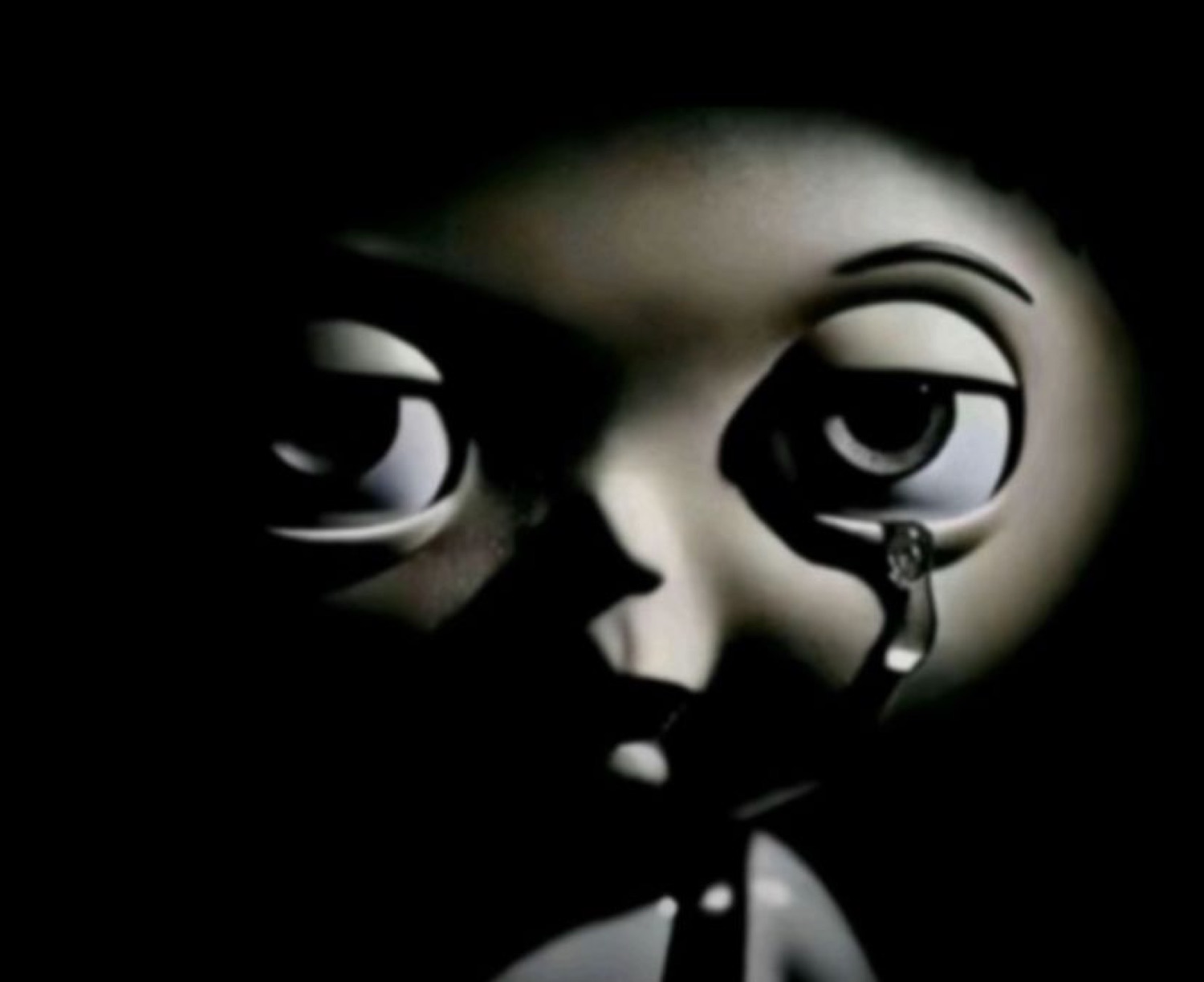 Dark animated doll face shedding a single tear in dramatic close-up