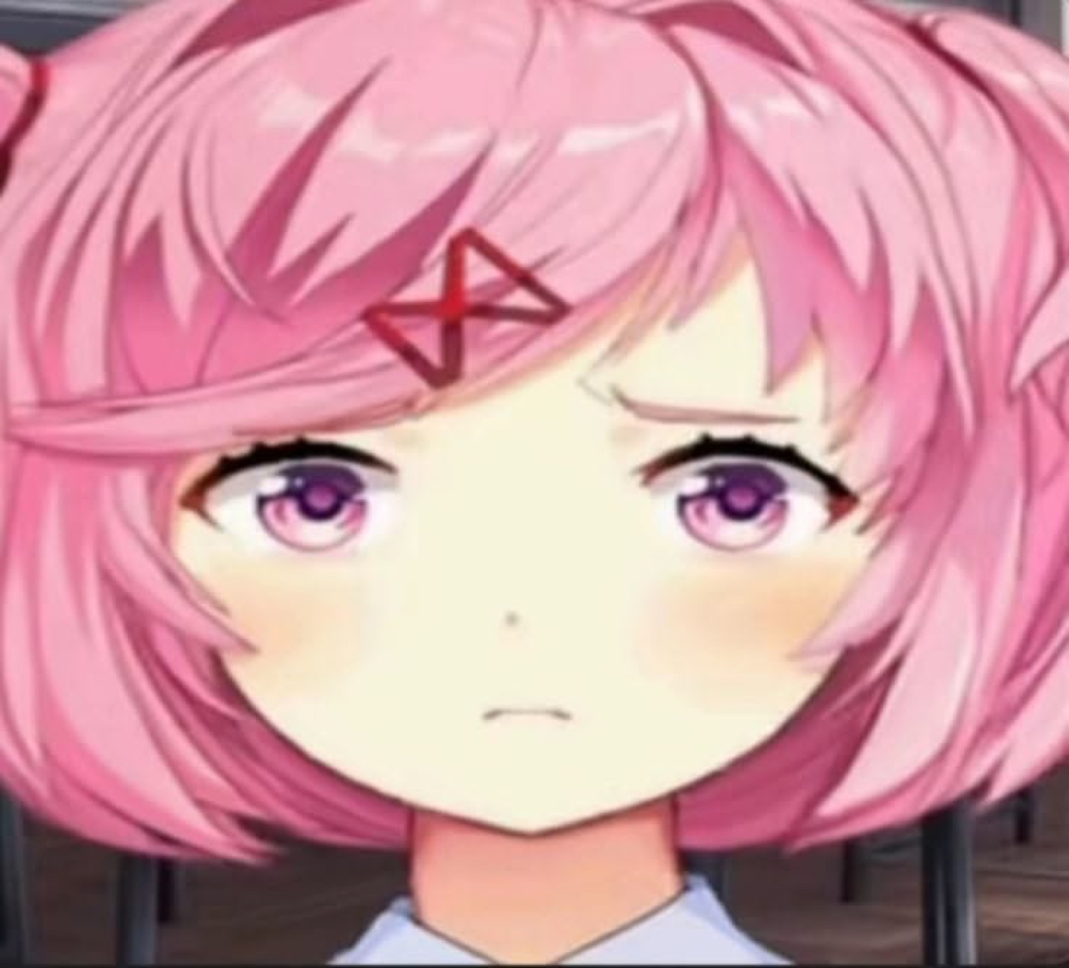 Pink-haired anime girl with a dejected, unimpressed pout staring straight ahead