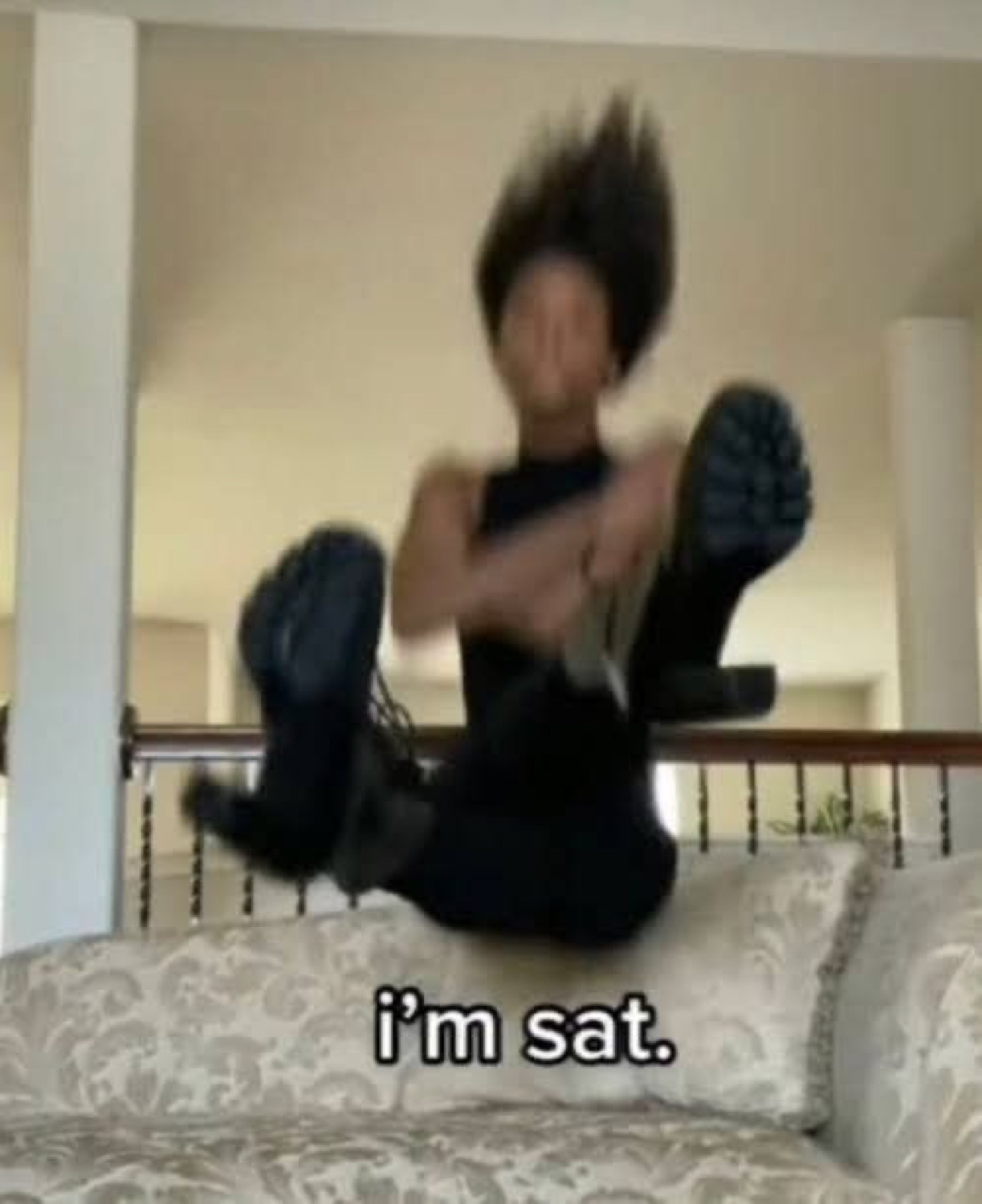 Person flopped back on a couch with hair flying, captioned 'i'm sat.'