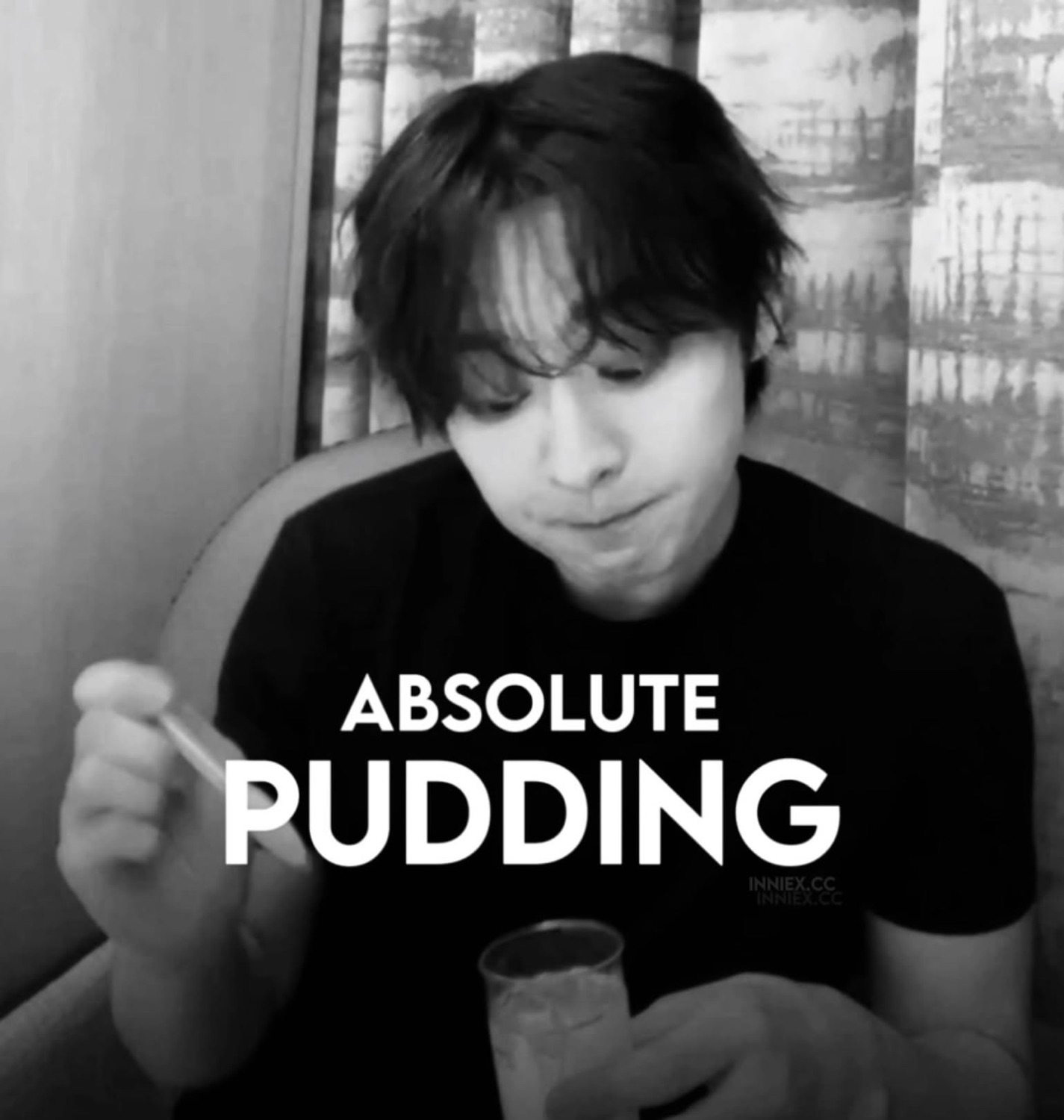Black and white shot of a guy eating dessert captioned 'ABSOLUTE PUDDING'