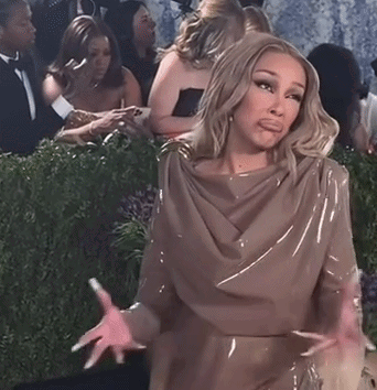Jennifer Coolidge in a satin dress shrugging