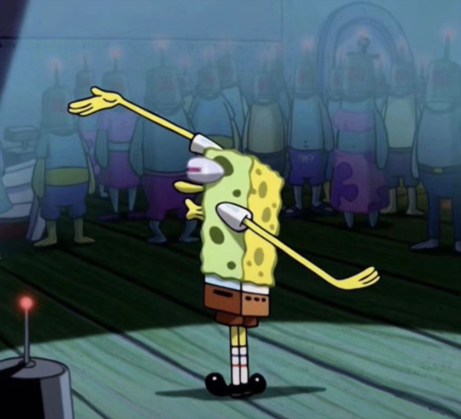 SpongeBob hitting a full dab on stage while the crowd stands behind him