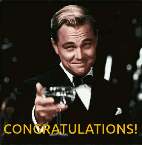 Leonardo DiCaprio as Gatsby raising a champagne glass, "Congratulations!"