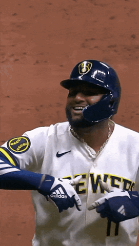 Milwaukee Brewers player in uniform crossing his arms and nodding with a confident look