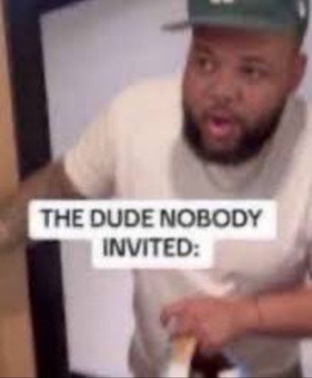 Uninvited guy leaning in through a doorway mid-sentence, captioned 'THE DUDE NOBODY INVITED:'