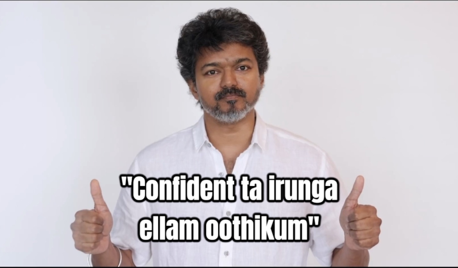 Vijay giving two thumbs-up: '"Confident ta irunga ellam oothikum"' (stay confident, it'll all work out)