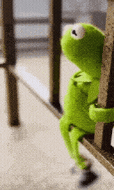 Kermit the Frog slowly sliding down a railing in boredom