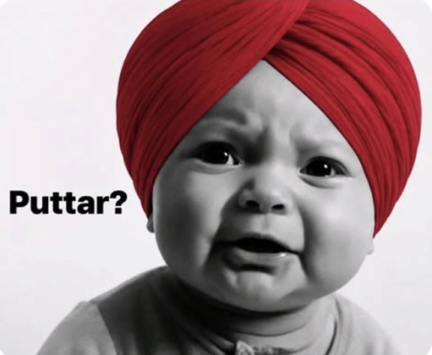 Black-and-white baby in a turban about to cry: 'Puttar?'