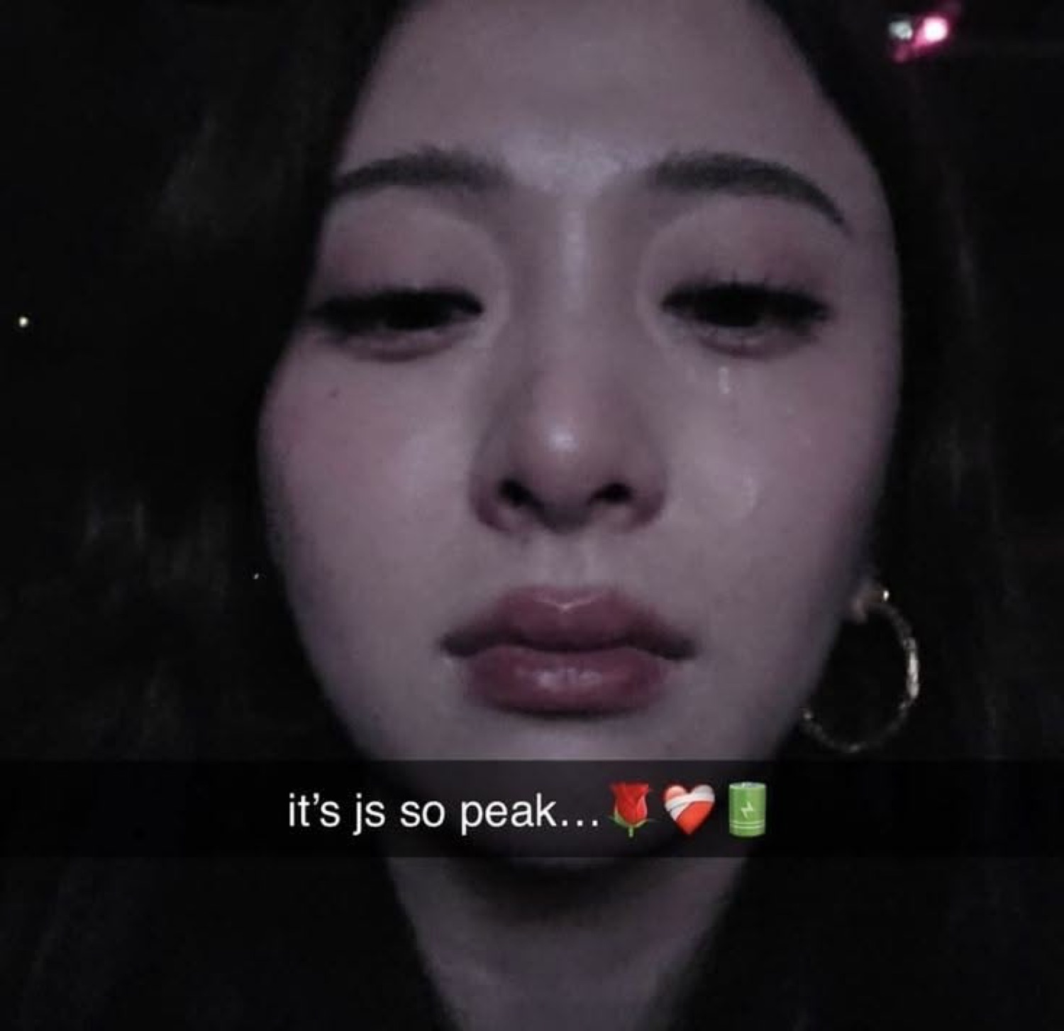 Young woman crying silently with tears on her cheeks, captioned 'it's js so peak...'