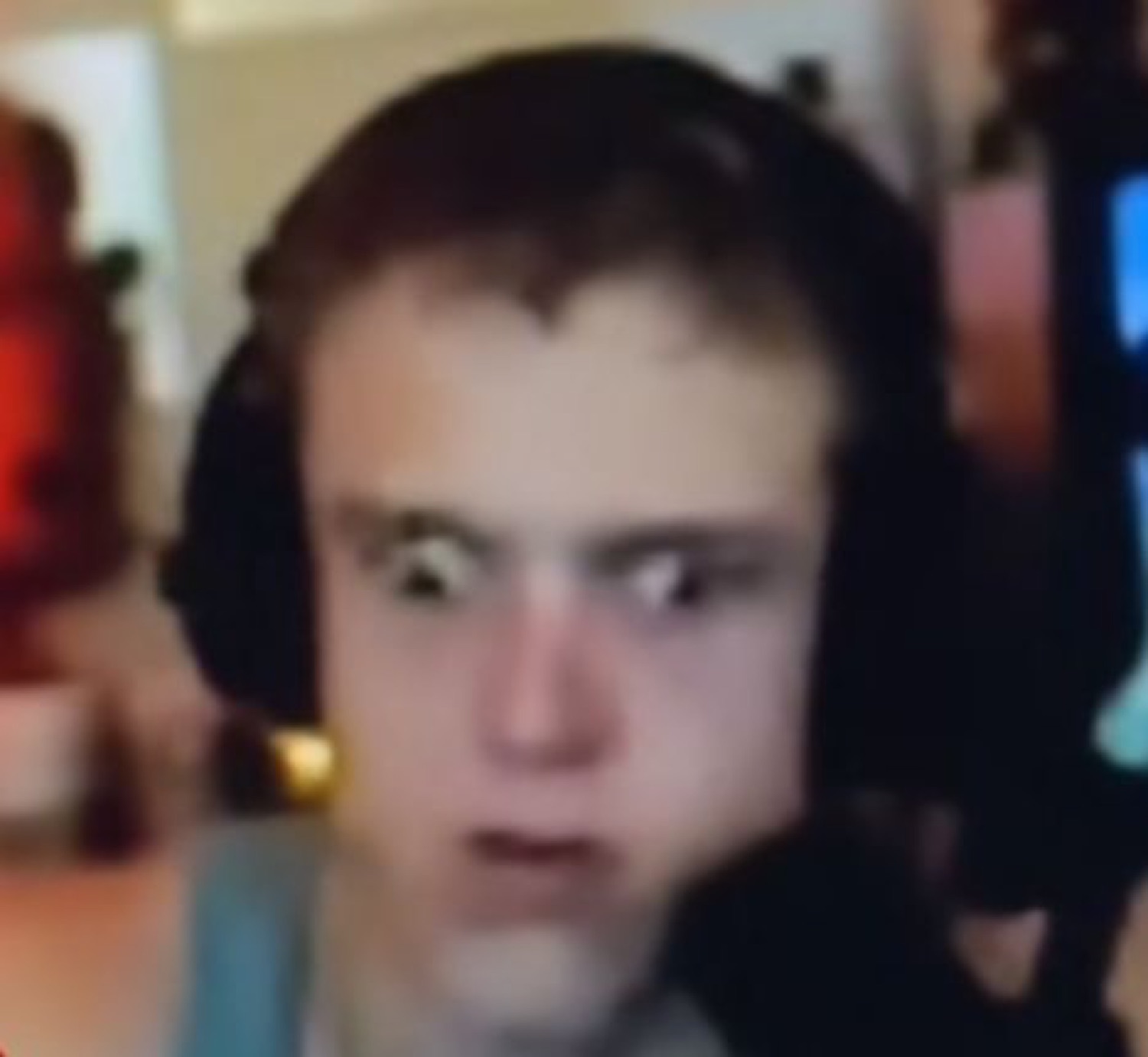 Blurry gamer in headphones with a wide, stunned thousand-yard stare