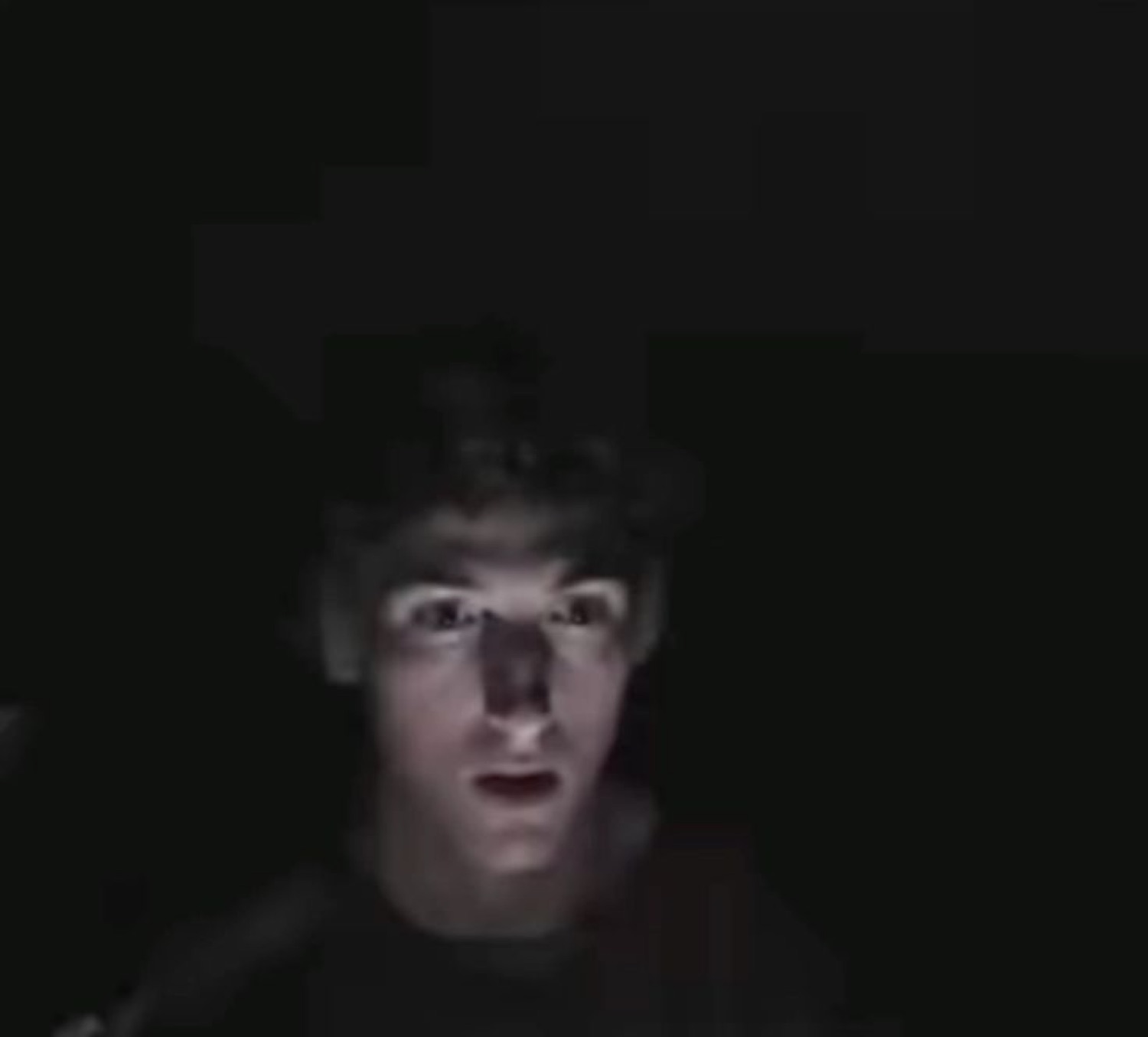 Guy lit only by his screen in a pitch-black room, mouth hanging open
