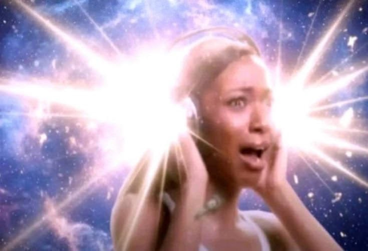 Woman with hands on face gasping in awe surrounded by an exploding cosmic light burst