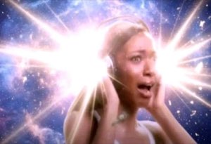Woman with hands on face gasping in awe surrounded by an exploding cosmic light burst