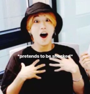 Guy in a bucket hat clutching his chest, captioned '*pretends to be shocked*'