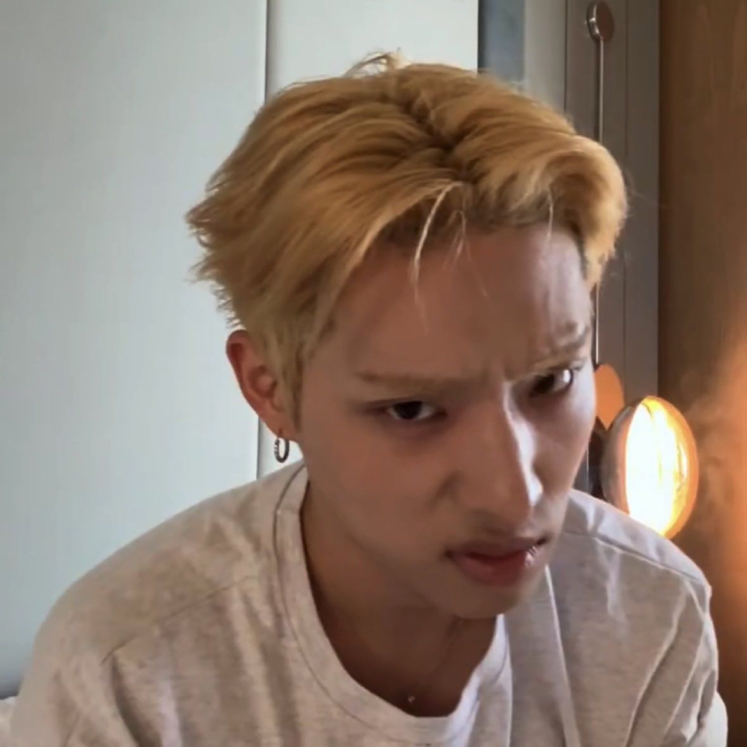 Blond guy squinting at the camera with a full-on disgusted grimace