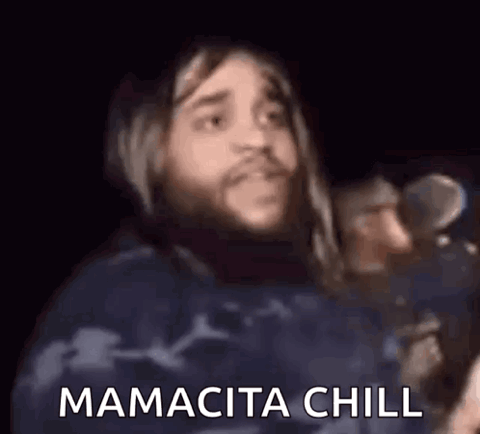 Long-haired man singing into a microphone, "Mamacita chill"