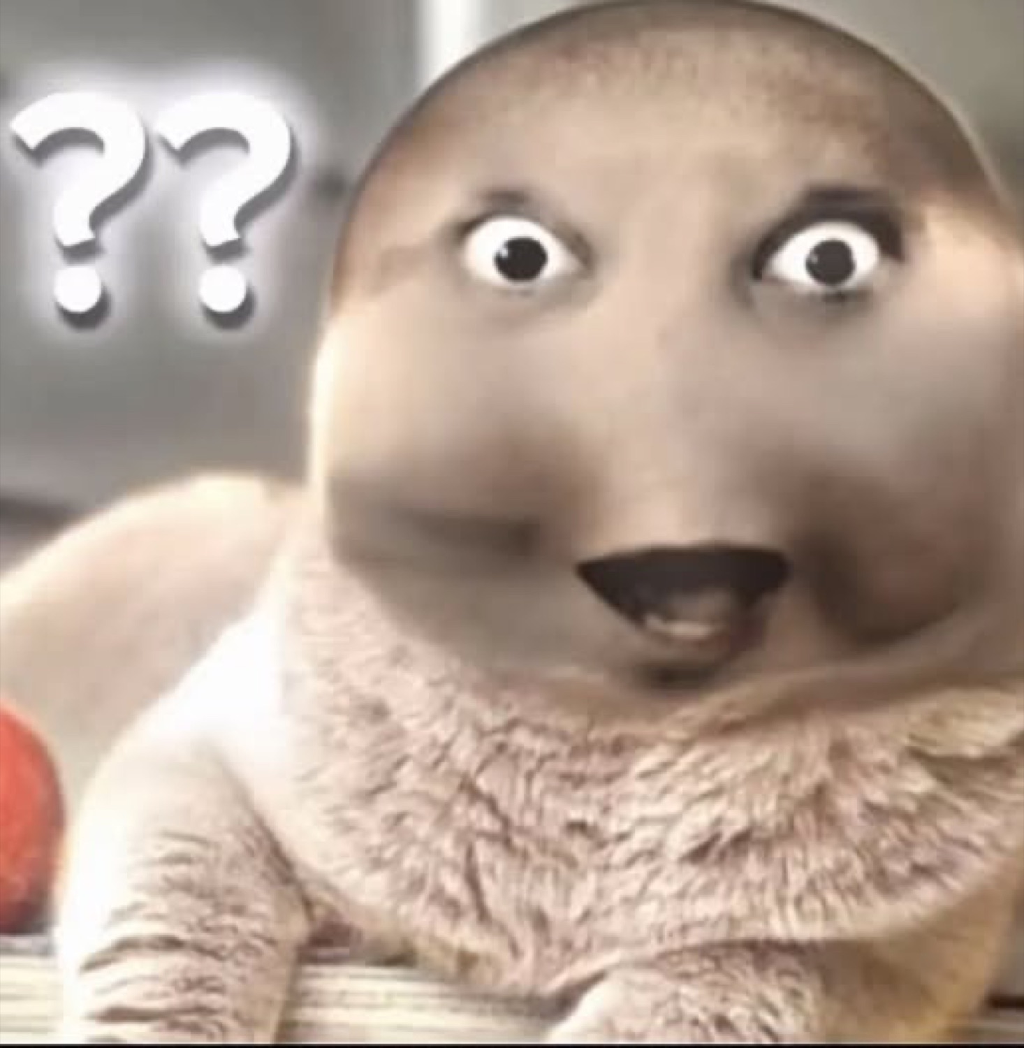 Smooth seal-like creature with a human face and '??' beside it