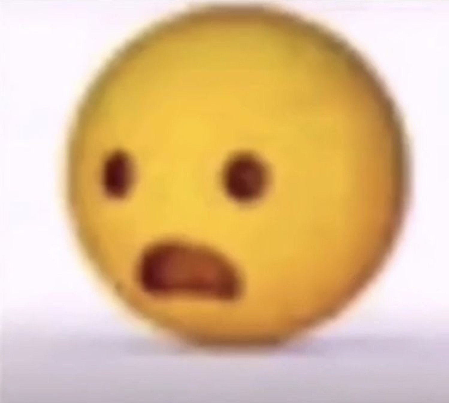 Blurry yellow emoji face frozen with a shocked, frowning open mouth