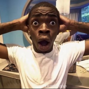 Man with hands behind his head, eyes wide and jaw dropped in stunned disbelief