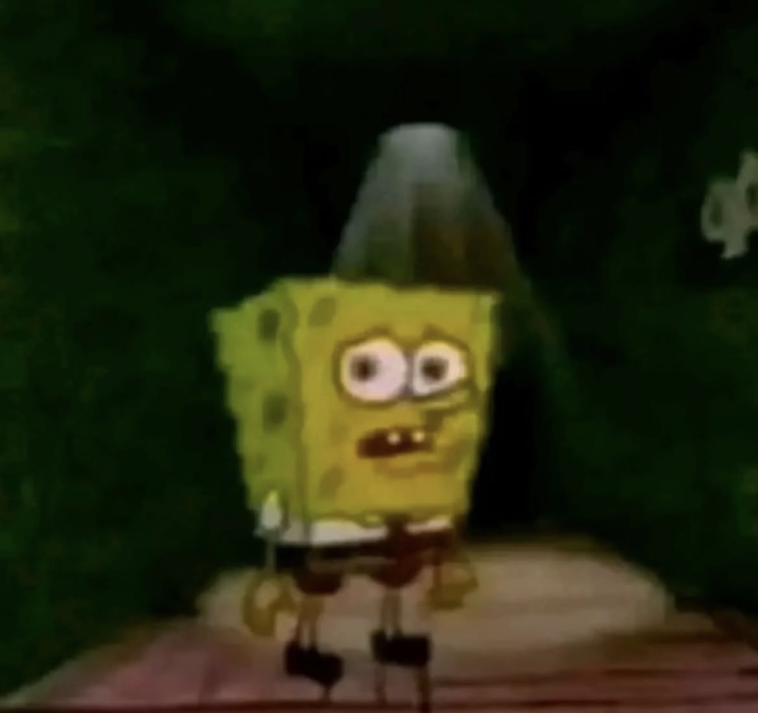 SpongeBob running wild-eyed with a sombrero on his head in a dark spooky setting