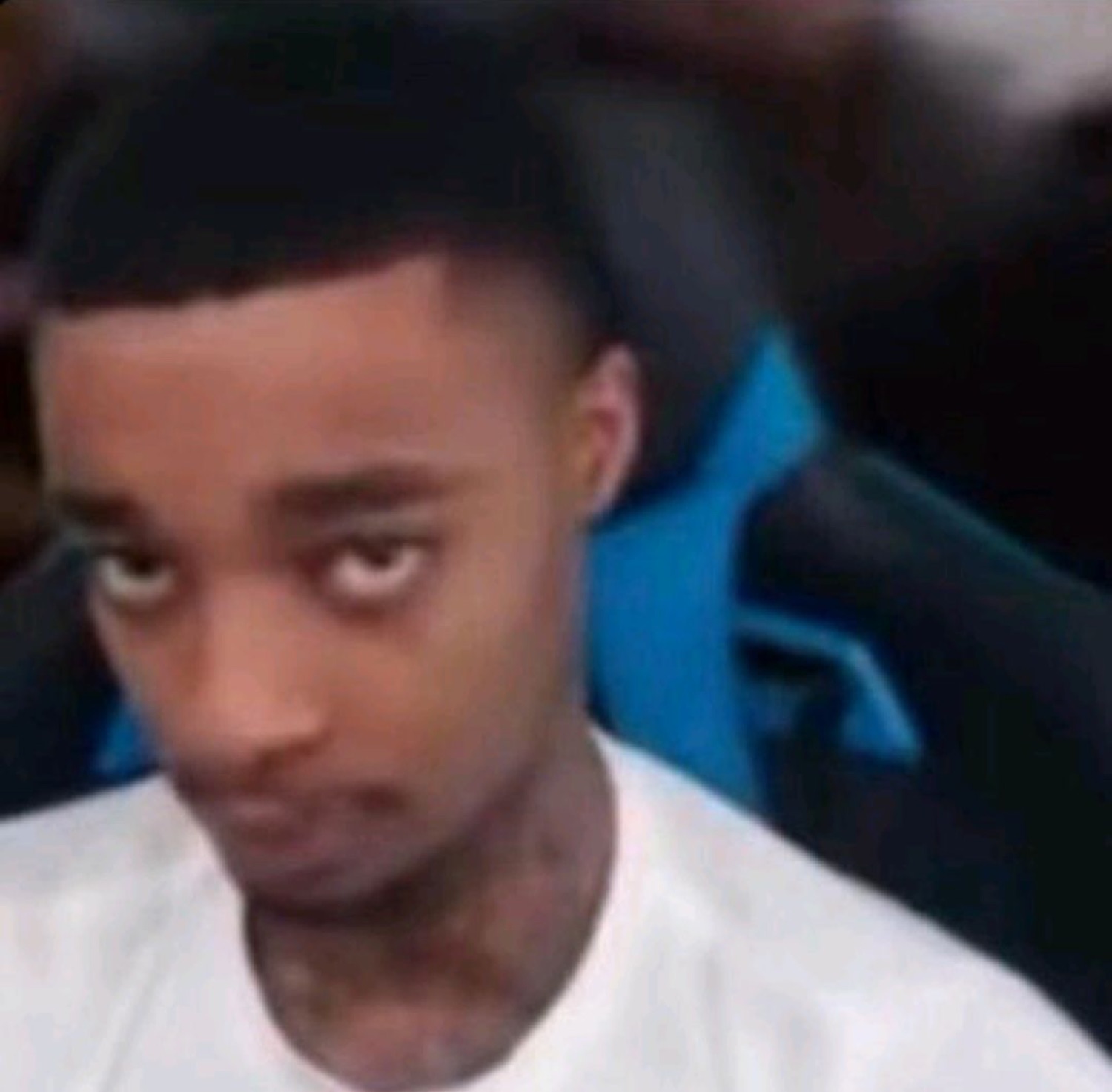 Young man glancing to the side with a wary, suspicious side-eye